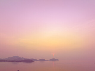 Aerial view stunning the golden sun shining above the island..Scene of colorful reflection on the sea surfect. sweet sky cover the ocean..Gradient color. Sky texture, abstract nature background..