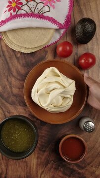 Vertical food video, Putting a plate with Oaxaca cheese or quesillo, mexican dinner