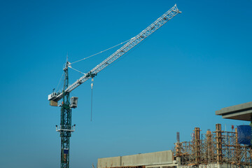 Crane and building construction site with the blue sky