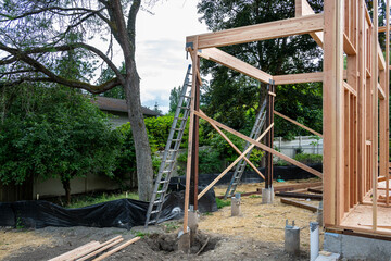 New house construction in residential neighborhood, job site detail of back of home foundation,...