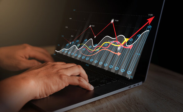 Businessmen using laptops to view company financial reports and graph showing financial growth data and figures. Concept, planning, strategy, analysis, growth, and profit in financial management.