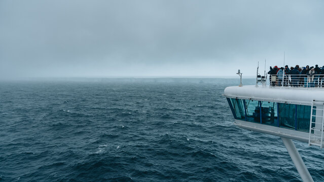 Antarctica - December 26th 2023 - Photo of A23a Iceberg with Cruise Ship Wide View Passengers. Dozens of Tourists Photograph Huge Floating Ice