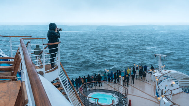Antarctica - December 26th 2023 - Photo of A23a Iceberg Wide View from Cruise Ship Behind Crowd. Passenger Photographs From Staircase Camera