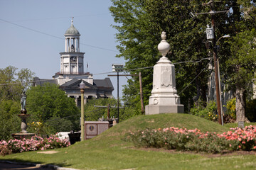 Vicksburg, Mississippi, USA - April 23, 2024: A rose garden and monument frame the historic Courthouse in the historic heart of downtown Vicksburg.