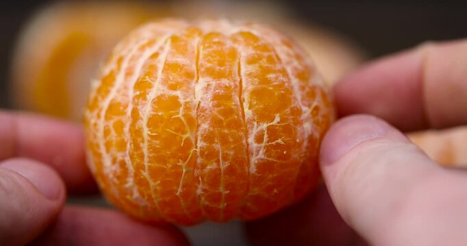 peeled ripe sweet tangerine, mandarin fruit without shell on a wooden blackboard