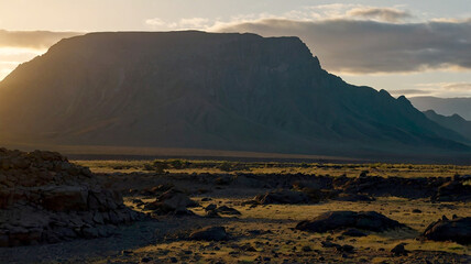 A majestic mountain range with snowcapped peaks and lush green valleys stretching endlessly