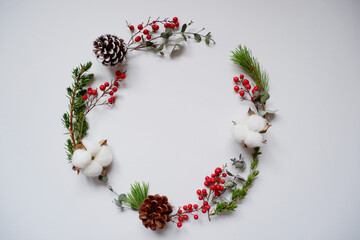 Winter green, cotton flowers, acorns and red berries decoration wreath. natural green decoration...