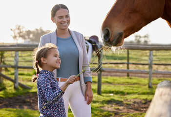 Farm, mother and child with feeding of horse for bonding, care and holiday at countryside. Happy, family and girl with plants in animal love at ranch for childhood, adventure and vacation in Texas
