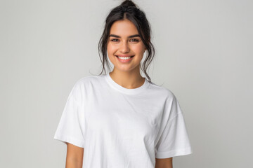 Fototapeta premium Young woman in white t shirt smiling on white background