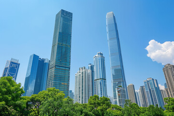 Obraz premium Skyscrapers Reaching into a Bright Blue Sky with White Clouds on a Sunny Day