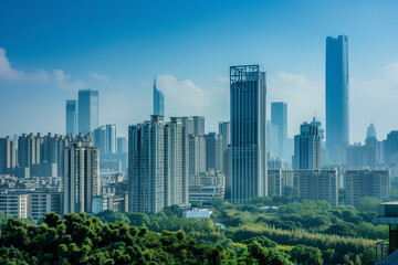 Obraz premium Skyscrapers Reaching into a Bright Blue Sky with White Clouds on a Sunny Day
