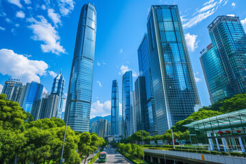 Obraz premium Skyscrapers Reaching into a Bright Blue Sky with White Clouds on a Sunny Day