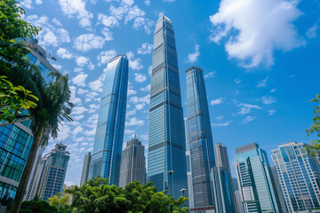 Fototapeta premium Skyscrapers Reaching into a Bright Blue Sky with White Clouds on a Sunny Day