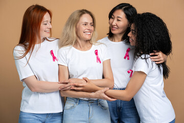 Diverse group of women embracing and supporting a friend fighting breast cancer