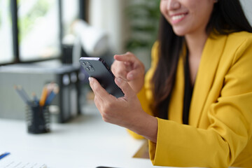 Confident Asian businesswoman Happy and positive person using smartphone to relax with mobile application. Use business conversations and connect with customers online Excellent profits.