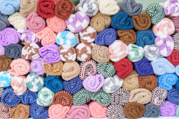 Many colorful rolls of cloth on the table