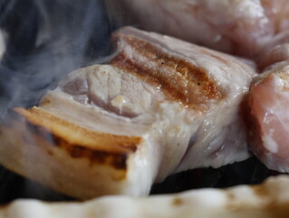 Korean bbq Grilled Prok Belly Samgyupsal on a grill, Korean favorite food 삼겹살