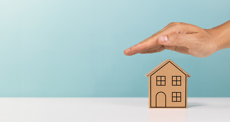 Protect property, mortgage, home, investment and financial savings concept. Hand protecting roof...