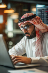 Middle Eastern Man Working on Laptop in Modern Office Setting