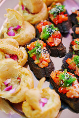 profiteroles and a baguette with vegetables on the banquet table. canapes for a buffet. catering services.