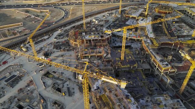 Drone view of Mega construction of Saudi Arabia on the sunset with plenty of cranes 