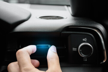 The driver hand adjusts the wind direction of the air vent in the modern car, button direction adjustment of the air conditioning system in the car, Automotive air conditioning concept 2024.