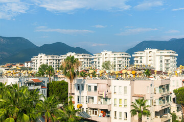 Obraz premium Apartment buildings, hotels, palms tree on the streets of Alanya, Turkey.