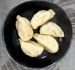 Kalmyk dumplings in a black plate