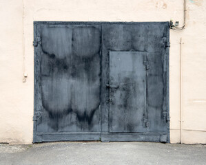 Metal gate on the wall of the building