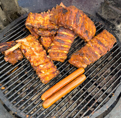 Barbecue meat is fried on a metal grate