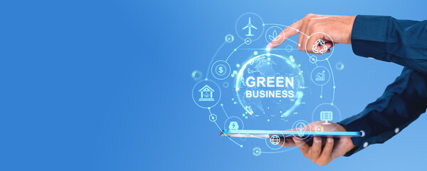 Businessman using tablet, finger touch green business hologram hud, copy space