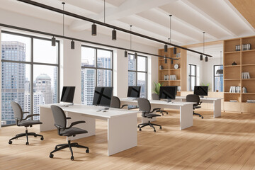 Office coworking interior with tables and pc monitors, panoramic window