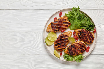 grilled chicken breasts wrapped in bacon on plate