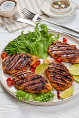 grilled chicken breasts wrapped in bacon on plate