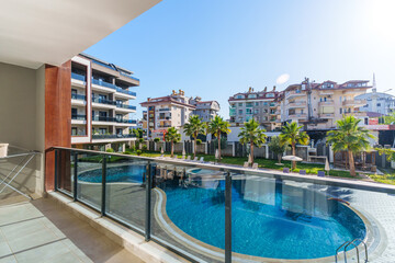 A shot from a balcony overlooking a swimming pool