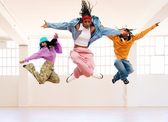 YYoung group of multiethnic hip-hop dancers wearing colorful urban streetwear dancing - Stylish multiracial rap crew portrait in indoors dancing studio