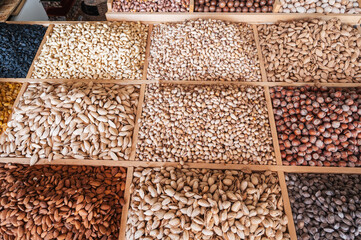 assortment of different variety nuts on counter at the eastern Uzbek food bazaar. Almonds, pistachios, hazelnuts, macadamia, pecans and cashews