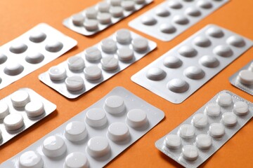 Pills in blisters on a colored background