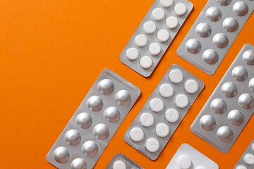 Pills in blisters on a colored background