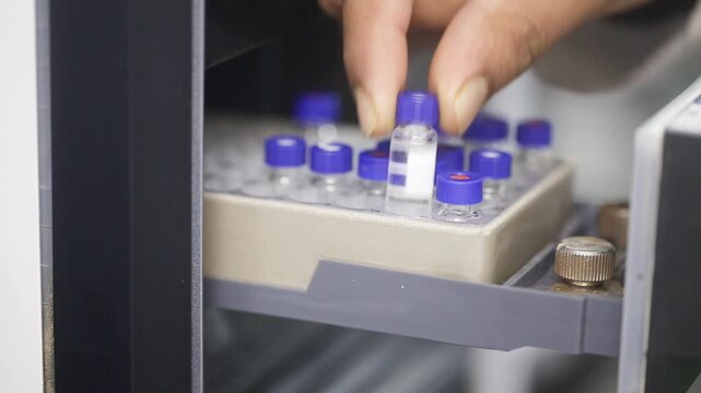 Fda approved hplc lab, close up of science experiment Vials filling inside an autosampler of an HPLC machine inside view in a Science experiment laboratory research development analysis	