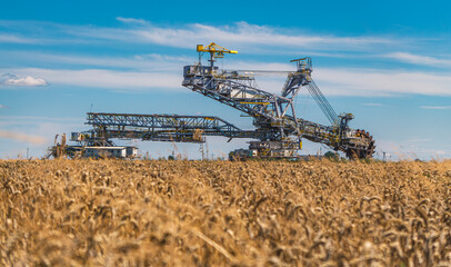 Digging machine, coal mining machine, huge mining equipment. metal machine for mining non-ecological coal. pile of metal, scrap. driving ropes, control cabin © Adam