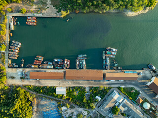 High angle view fisherman boats at the jetty located in Phuket Thailand, aerial view drone top down view,Siray fishing port Phuket Thailand