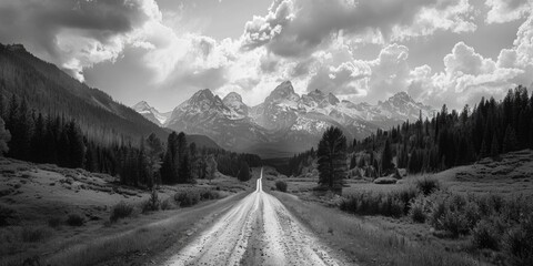 A classic image of a dirt road winding through the mountains, shot in black and white © Fotograf