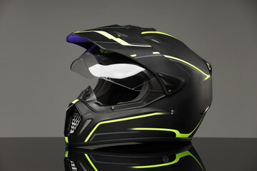 Modern motorcycle helmet with visor on mirror surface against light grey background