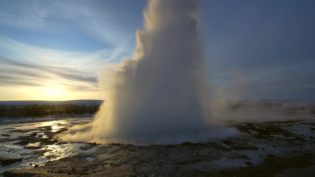 Beautiful eruption of the Strokkur Geyser at sunrise. Iceland's frozen winter is very cold