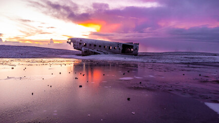 Aerial drone view at sunrise on crashed plane on frozen Solheimasandur beach in winter, Iceland