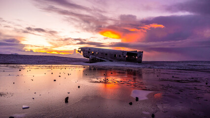 Beautiful aerial drone view at sunrise on crashed plane on frozen Solheimasandur beach in winter, Iceland
