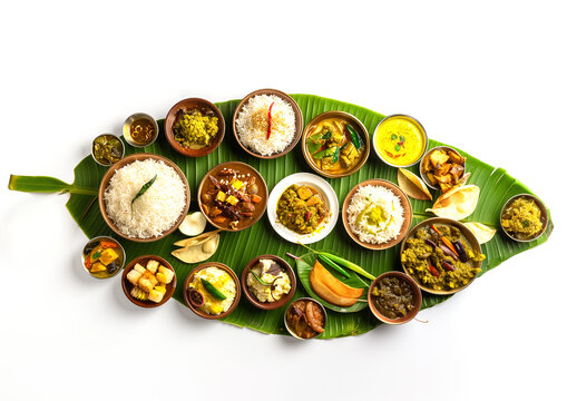 Traditional food Onam sadhya served on banana green leaf, south indian vegeterian meal arranged in traditional way. Onam Sadya vegetarian meal with rice and curries, kerala food, Kerala, india. 