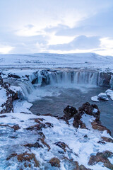 Amazing scenery of frozen Godafoss waterfall at sunset in winter, Iceland.
