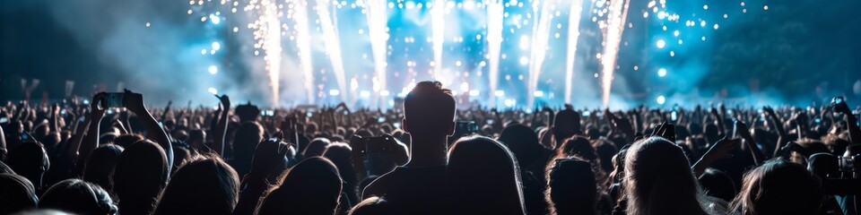 a panorama of a concert at night with fireworks